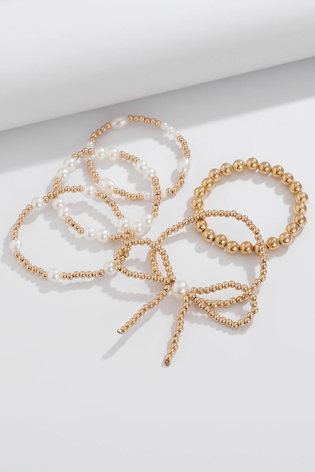 Set di Bracciali Multistrato con Fiocco Dorato e Perle - Image 4